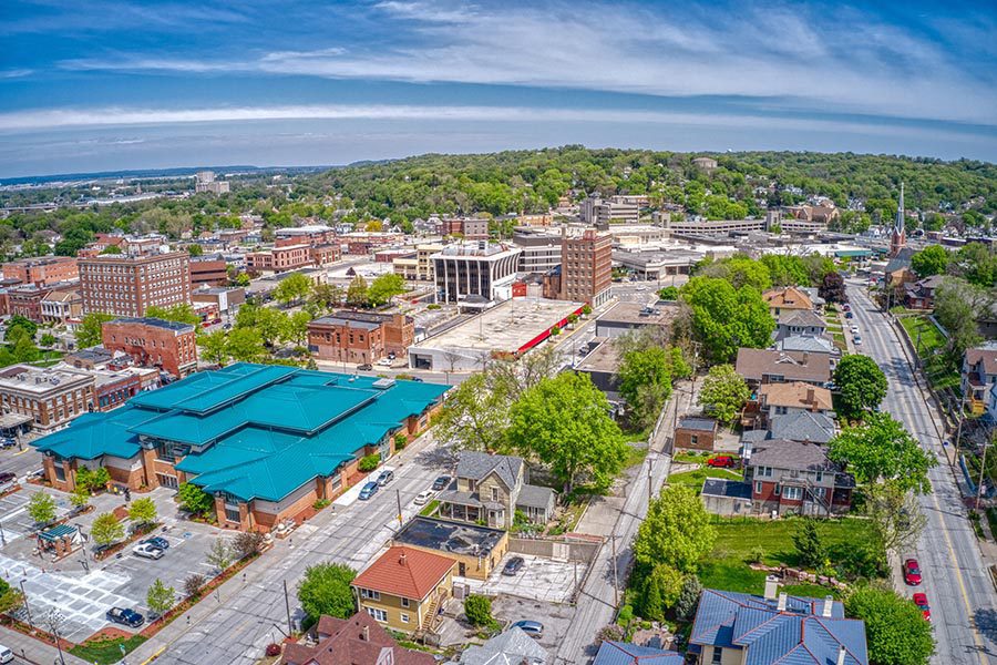 Contact - Aerial View of Businesses and Homes in a Small Town on a Bright Day